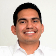 Man with dark hair wearing a white collared shirt smiling